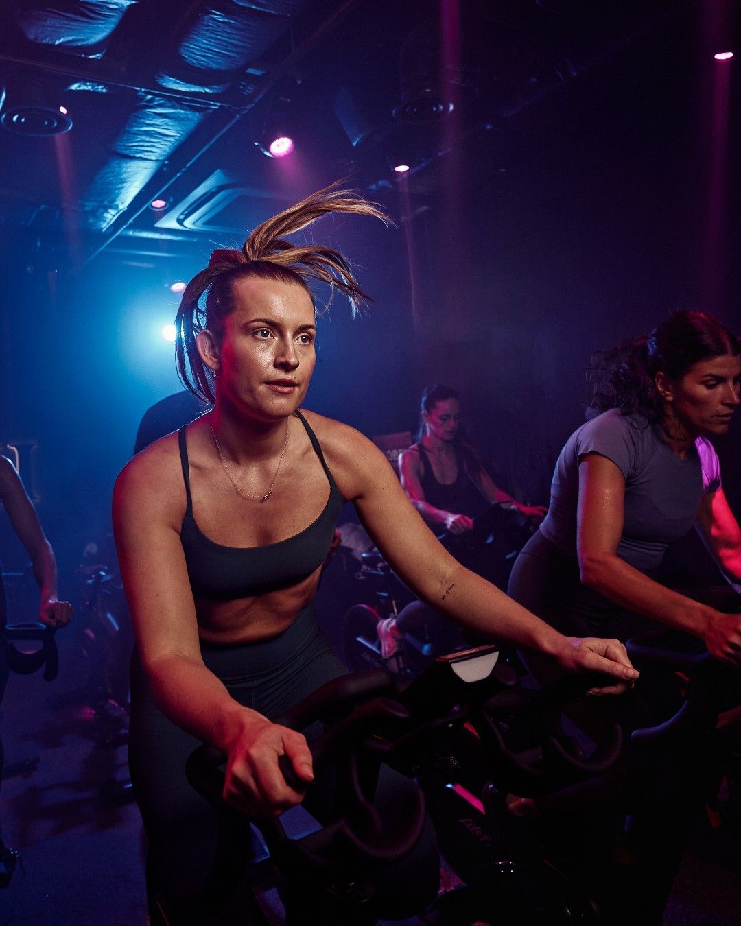 The cycling studio at Vy Boutique, lit in blue